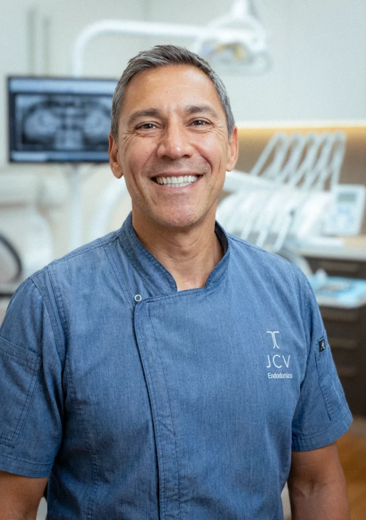 portrait of Dr Juan Camilo Villegas at his surgery and smiling at the camera