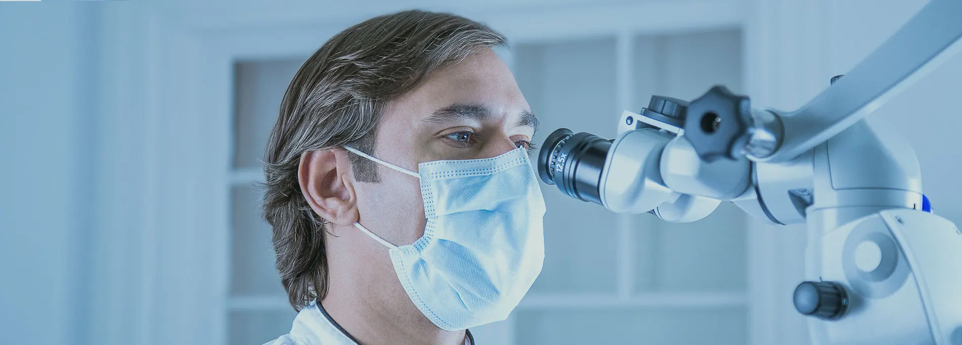 Clinician using an operating microscope during endodontic treatment
